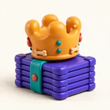 A modelling-clay crown sitting on a stack of cards.